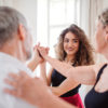 Dance teacher training a couple for a dance professional examination