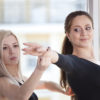 A female Latin American dancer being taught by a qualified dance teacher